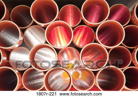 Brown PVC pipes stacked in construction site View Large Photo Image Stock Image - Brown PVC pipes stacked in construction site. Fotosearch