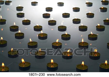 Stock Image - Burning tea lights. Fotosearch