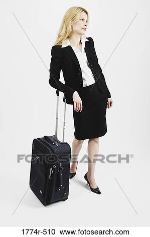 Businesswoman leaning against luggage and looking frustrated View Large Photo Image Stock Image - Businesswoman leaning against luggage and looking frustrated. Fotosearch