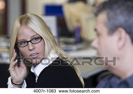 Stock Image - Businesswoman talking on a mobile phone, Florida, USA. Fotosearch