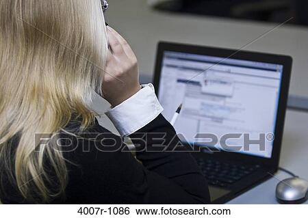 Stock Photograph - Businesswoman using a laptop, Florida, USA. Fotosearch