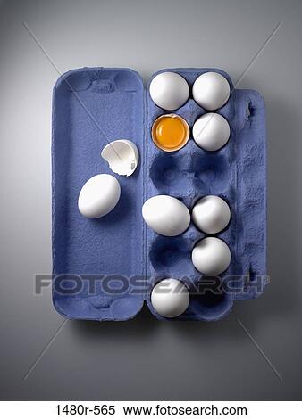Stock Photography - Carton of eggs with a broken egg. Fotosearch