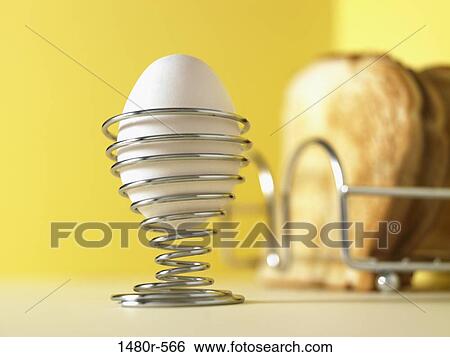 Close-up of a boiled egg in an eggcup with toasts View Large Photo Image Stock Photograph - Close-up of a boiled egg in an eggcup with toasts. Fotosearch