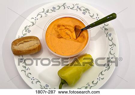 Close-up of a bread roll with dip in a bowl View Large Photo Image Stock Photo - Close-up of a bread roll with dip in a bowl. Fotosearch