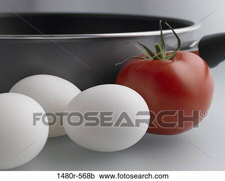 Close-up of a tomato with eggs and a pan View Large Photo Image Stock Image - Close-up of a tomato with eggs and a pan. Fotosearch