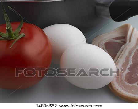 Close-up of a tomato with eggs and bacon View Large Photo Image Stock Image - Close-up of a tomato with eggs and bacon. Fotosearch