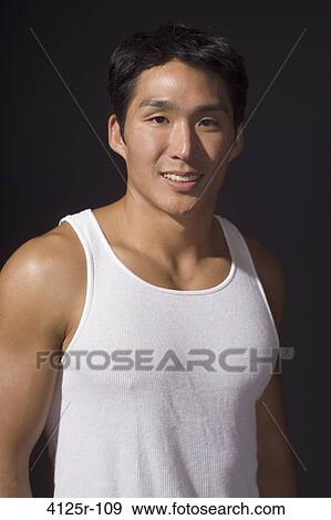 Close-up of a young man smiling View Large Photo Image Stock Photo - Close-up of a young man smiling. Fotosearch