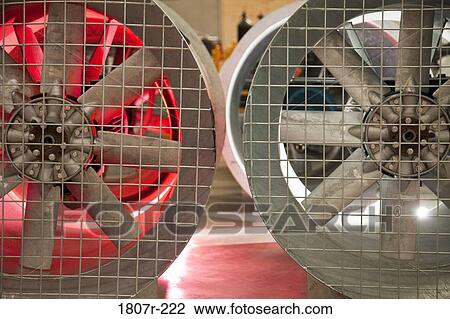 Close up of industrial fans behind metal grate View Large Photo Image Stock Image - Close up of industrial fans behind metal grate. Fotosearch
