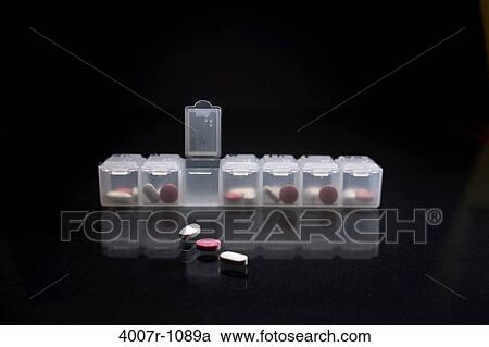 Stock Image - Close-up of pills with a pill box. Fotosearch