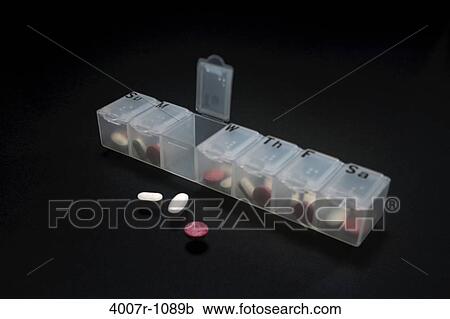 Stock Image - Close-up of pills with a pill box. Fotosearch