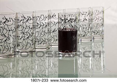 Empty glasses with pattern in row with one filled with drink View Large Photo Image Stock Image - Empty glasses with pattern in row with one filled with drink. Fotosearch