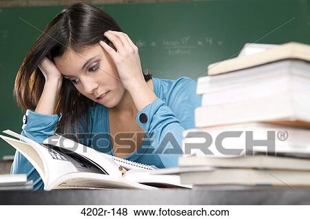 Female student studying in a classroom View Large Photo Image Stock Photo - Female student studying in a classroom. Fotosearch