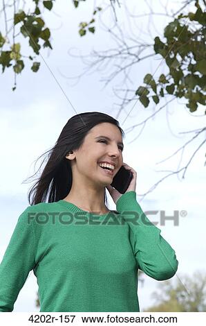 Female student talking on a mobile phone View Large Photo Image Stock Photo - Female student talking on a mobile phone. Fotosearch