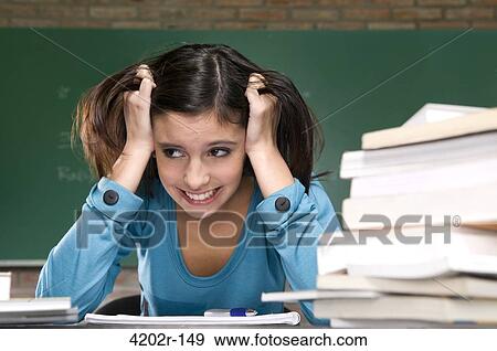 Female university student looking worried while studying View Large Photo Image Stock Photo - Female university student looking worried while studying. Fotosearch