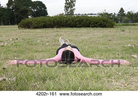 Female university student lying in grass View Large Photo Image Stock Image - Female university student lying in grass. Fotosearch