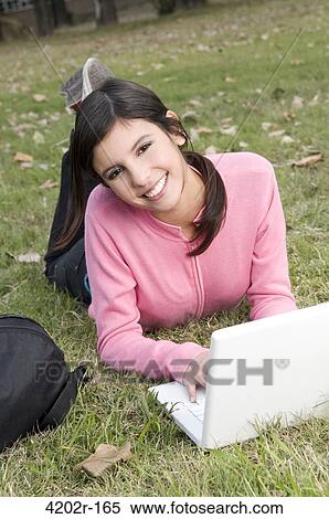 Stock Photography - Female university student with a laptop in campus. Fotosearch