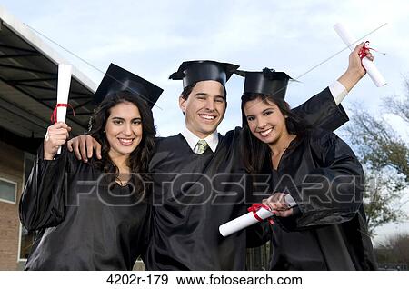 Stock Photo - Graduates holding diplomas and smiling. Fotosearch