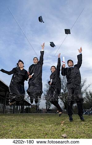 Graduates throwing mortar boards in the air View Large Photo Image Stock Image - Graduates throwing mortar boards in the air. Fotosearch