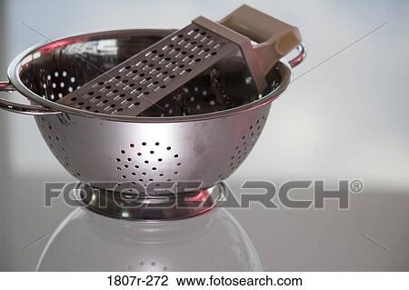 Grater in a colander on a table View Large Photo Image Stock Image - Grater in a colander on a table. Fotosearch