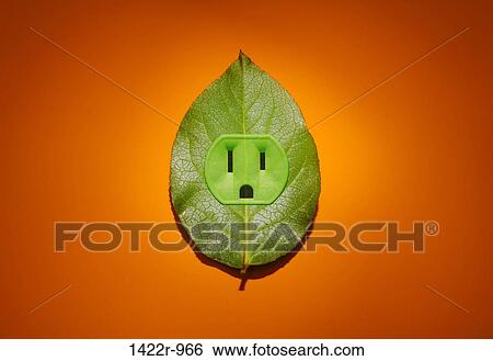 Stock Photograph - Green plant leaf with an electrical outlet on an orange background. Fotosearch