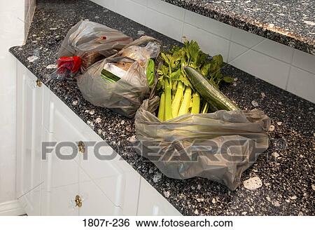 Grocery bags in kitchen View Large Photo Image Stock Photograph - Grocery bags in kitchen. Fotosearch