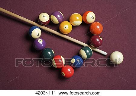 Stock Image - Heart shaped billiard balls with cue ball and stick. Fotosearch