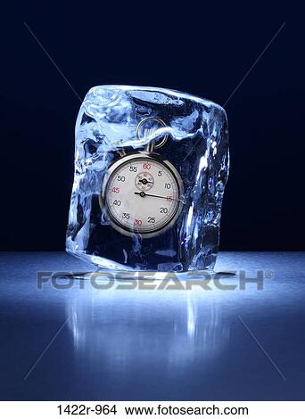 Picture - Large block of ice with a stopwatch frozen inside. Fotosearch