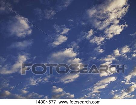 Stock Photo - Low angle view of clouds in the sky. Fotosearch