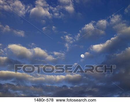 Stock Photo - Low angle view of clouds in the sky. Fotosearch