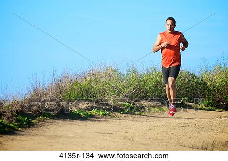 Picture - Male triathlete running on trail, San Elijo, Solana Beach, California, USA. Fotosearch