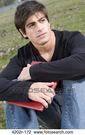 Male university student at a campus View Large Photo Image Stock Image - Male university student at a campus. Fotosearch
