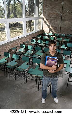 Male university student in a classroom View Large Photo Image Stock Image - Male university student in a classroom. Fotosearch