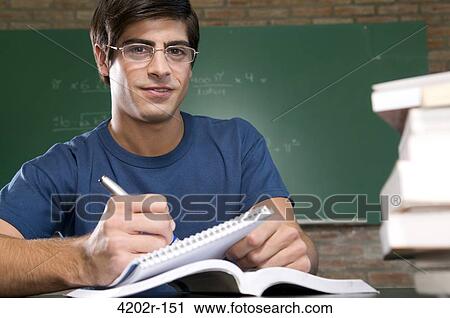 Male university student studying in a classroom View Large Photo Image Stock Image - Male university student studying in a classroom. Fotosearch