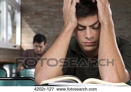 Male university student studying in a classroom View Large Photo Image Stock Photo - Male university student studying in a classroom. Fotosearch