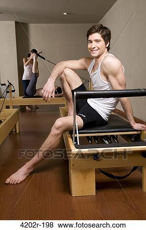 Man sitting on a exercise machine and smiling View Large Photo Image Stock Photo - Man sitting on a exercise machine and smiling. Fotosearch