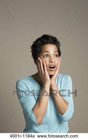 Mid adult woman looking shocked View Large Photo Image Stock Image - Mid adult woman looking shocked. Fotosearch