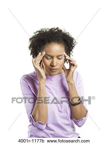 Mid adult woman suffering from a headache View Large Photo Image Stock Image - Mid adult woman suffering from a headache. Fotosearch