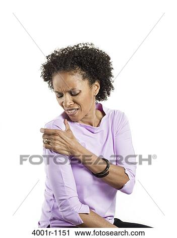 Stock Image - Mid adult woman suffering from pain. Fotosearch