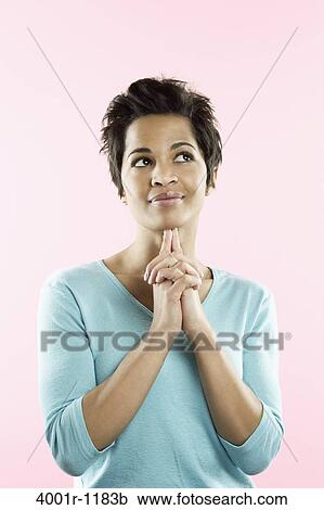 Mid adult woman with her hands clasped View Large Photo Image Stock Image - Mid adult woman with her hands clasped. Fotosearch