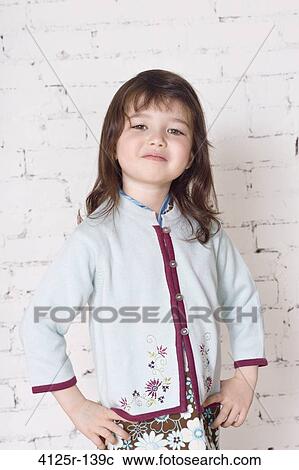 Mixed race Japanese girl smirking with hands on hips in studio with brick wall, USA View Large Photo Image Stock Image - Mixed race Japanese girl smirking with hands on hips in studio with brick wall, USA. Fotosearch
