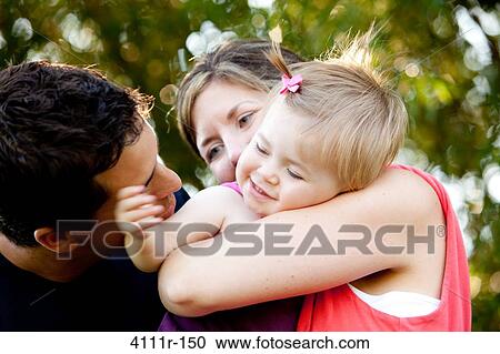 Stock Image - Parents with their daughter in a park, Traverse City, Grand Traverse County, Michigan, USA. Fotosearch