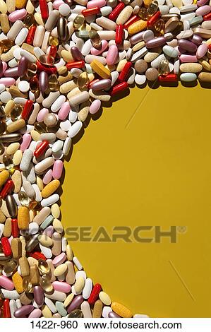 Stock Image - Partial oval shape in colorful multi-vitamin pills, tablets and capsules. Fotosearch