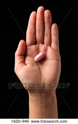 Pink capsule in the palm of a person View Large Photo Image Stock Photograph - Pink capsule in the palm of a person. Fotosearch
