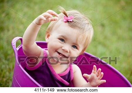 Portrait of a baby girl smiling in a bathtub, Traverse City, Grand Traverse County, Michigan, USA View Large Photo Image Stock Photo - Portrait of a baby girl smiling in a bathtub, Traverse City, Grand Traverse County, Michigan, USA. Fotosearch