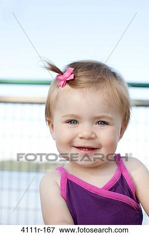 Portrait of a baby girl smiling, Traverse City, Grand Traverse County, Michigan, USA View Large Photo Image Stock Photo - Portrait of a baby girl smiling, Traverse City, Grand Traverse County, Michigan, USA. Fotosearch