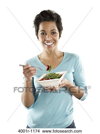 Portrait of a mid adult woman eating fruit salad View Large Photo Image Picture - Portrait of a mid adult woman eating fruit salad. Fotosearch