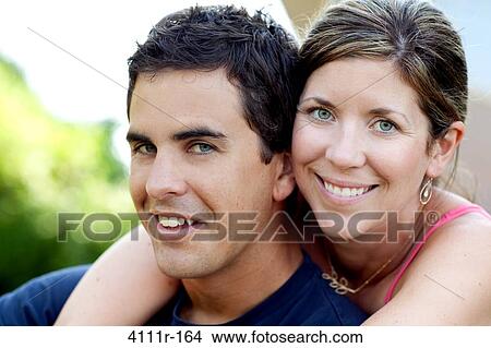 Portrait of a young couple smiling, Traverse City, Grand Traverse County, Michigan, USA View Large Photo Image Picture - Portrait of a young couple smiling, Traverse City, Grand Traverse County, Michigan, USA. Fotosearch