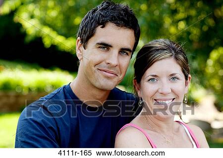 Portrait of a young couple smiling, Traverse City, Grand Traverse County, Michigan, USA View Large Photo Image Stock Photography - Portrait of a young couple smiling, Traverse City, Grand Traverse County, Michigan, USA. Fotosearch