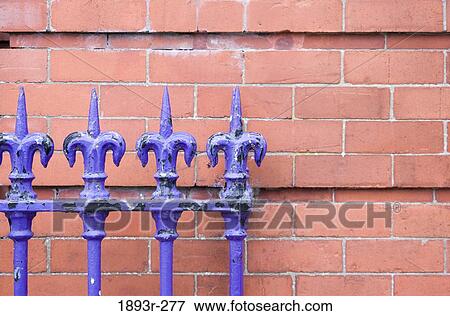 Stock Photo - Purple colored railing in front of red brick wall, Munster, County Clare, Republic of Ireland. Fotosearch