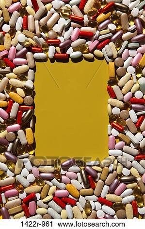 Stock Image - Rectangular shape in colorful multi-vitamin pills, tablets and capsules. Fotosearch